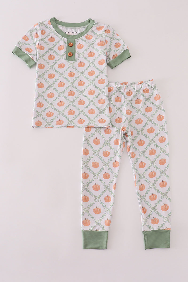 Children's pajama set with pumpkin pattern on a light gray background