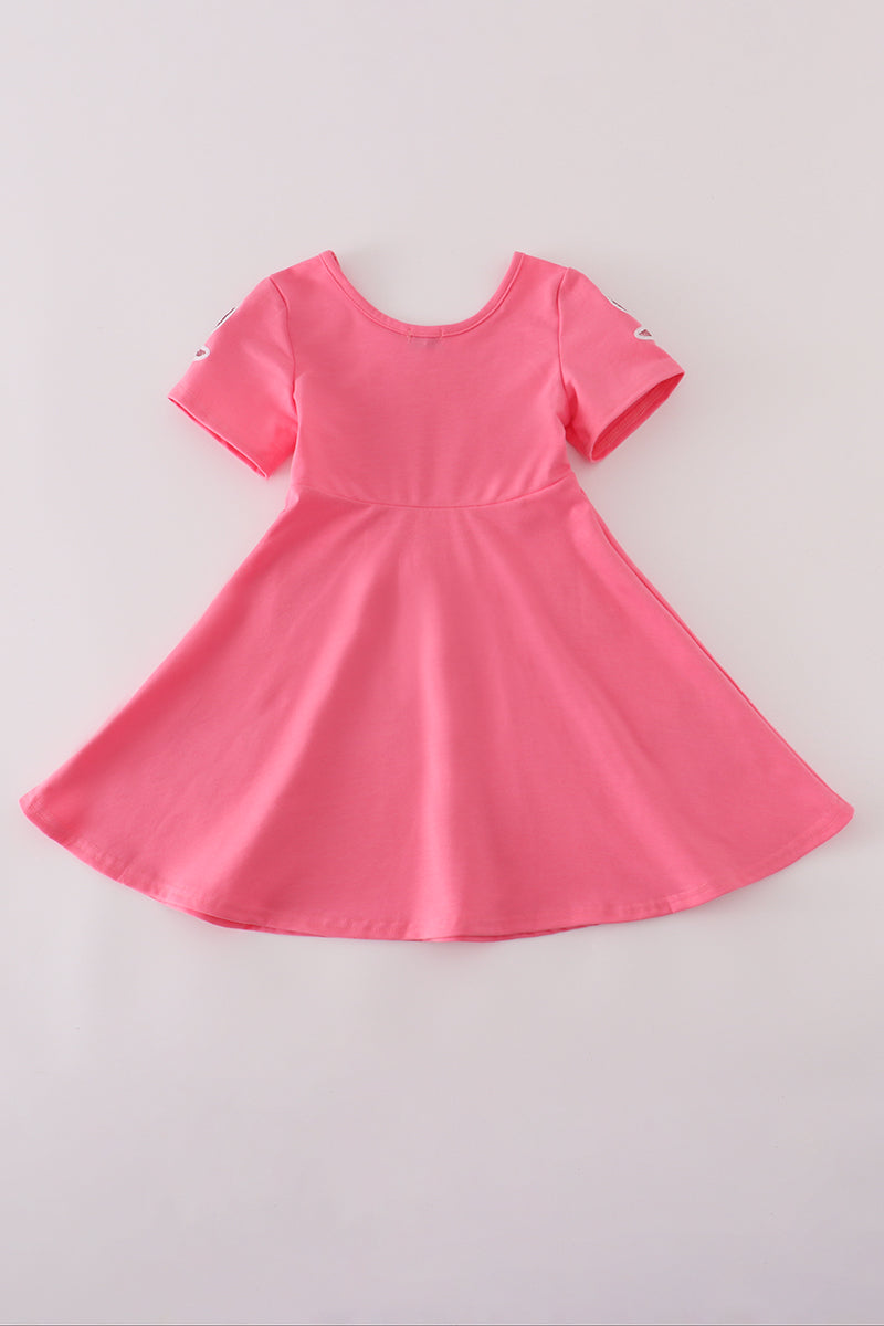 Pink dress with short sleeves on a light gray background