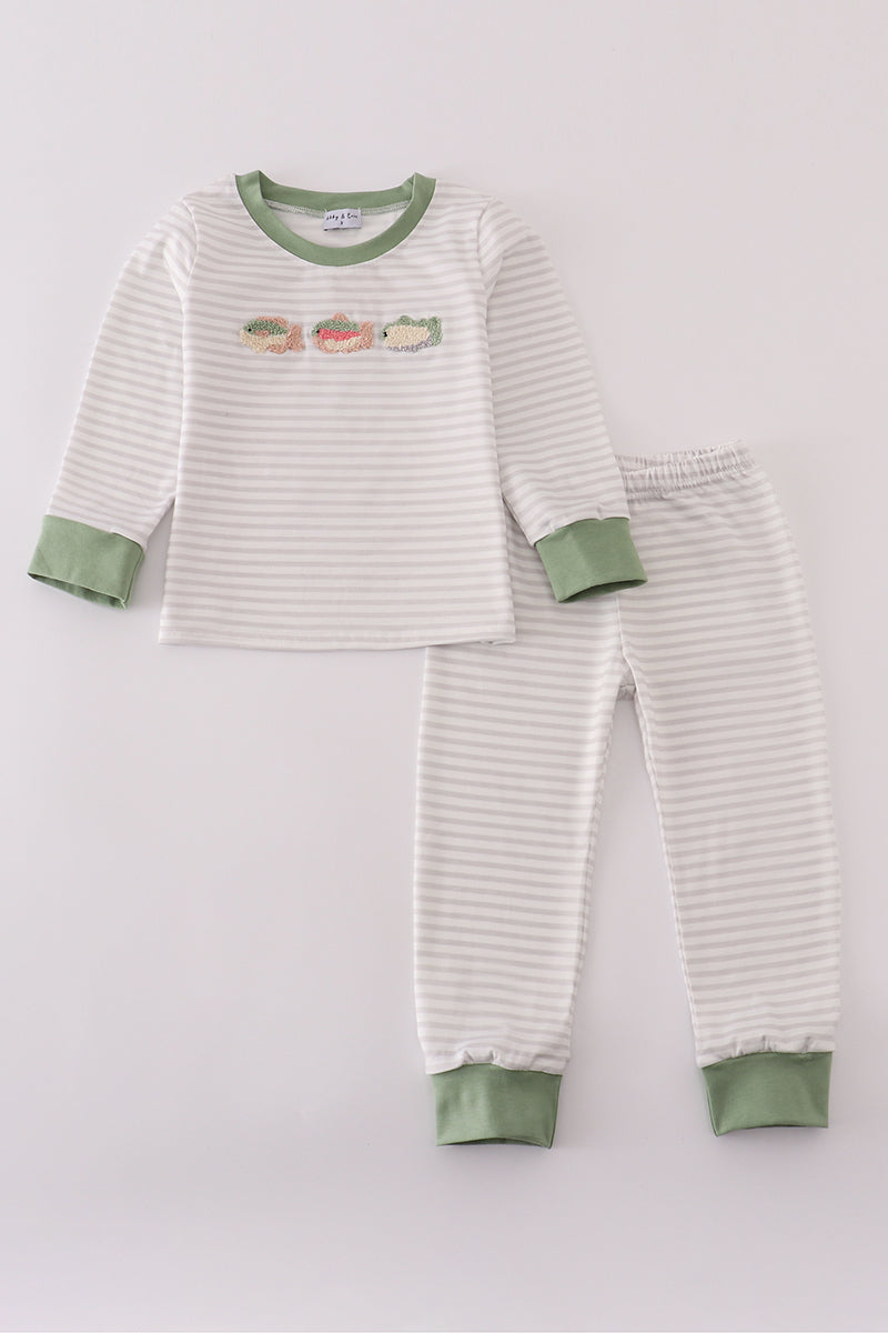 Children's striped pajama set with green accents on a light gray background