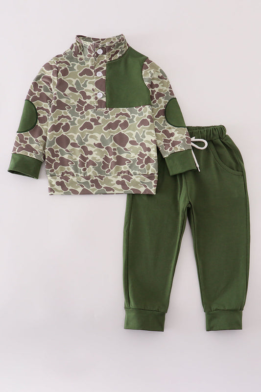 Children's camouflage shirt and green pants set on a light gray background