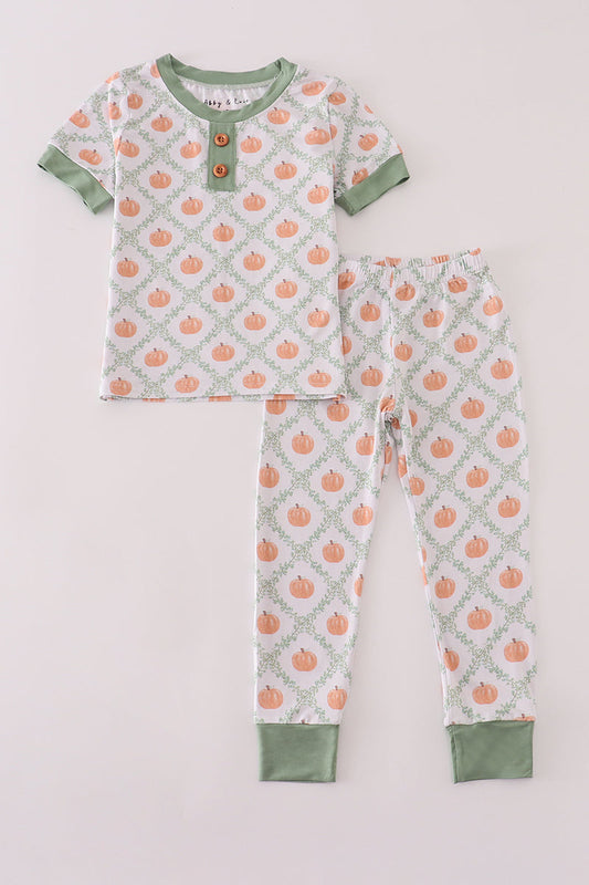 Children's pajama set with pumpkin pattern on a light gray background