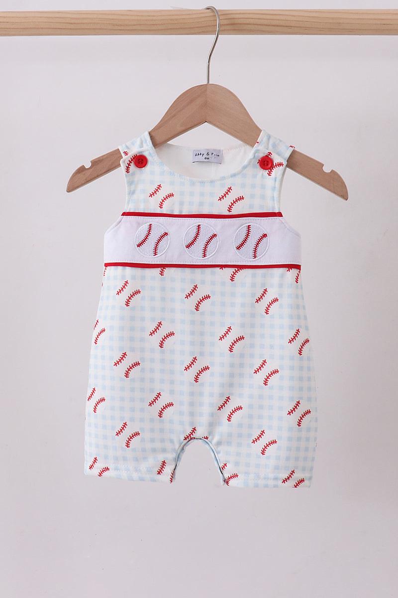 Baby romper with red pattern on a hanger against a white background