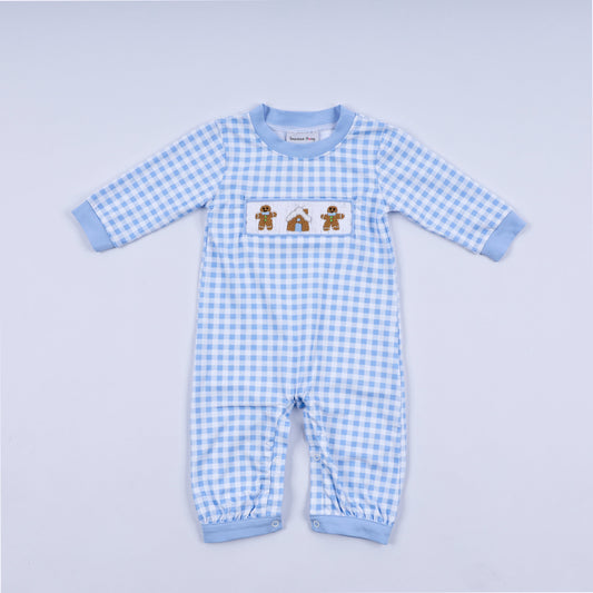 Blue gingham baby romper with gingerbread design on a light gray background