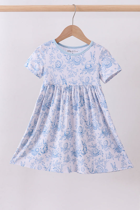 Children's dress with blue floral pattern on a hanger against a white background