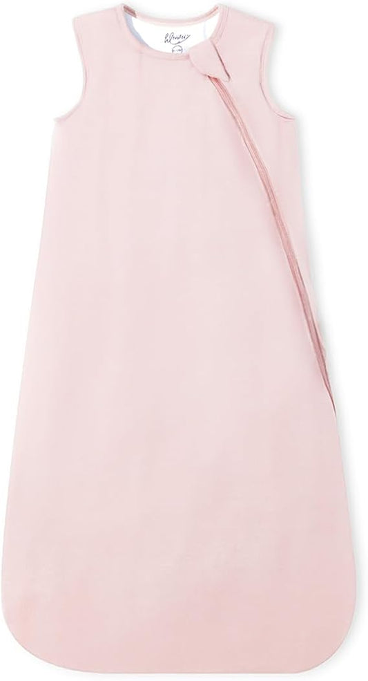 A light pink sleeveless baby sleep sack with a diagonal zipper, photographed flat against a white background.
