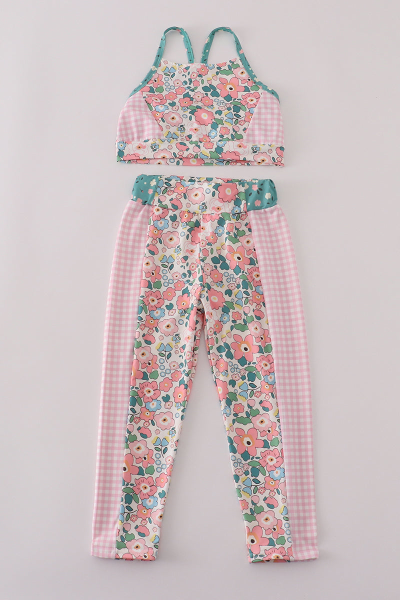 Floral and checkered outfit on a gray background