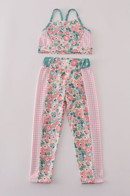Floral and checkered outfit on a gray background