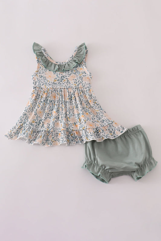 Floral dress and green bloomers set on a light gray background