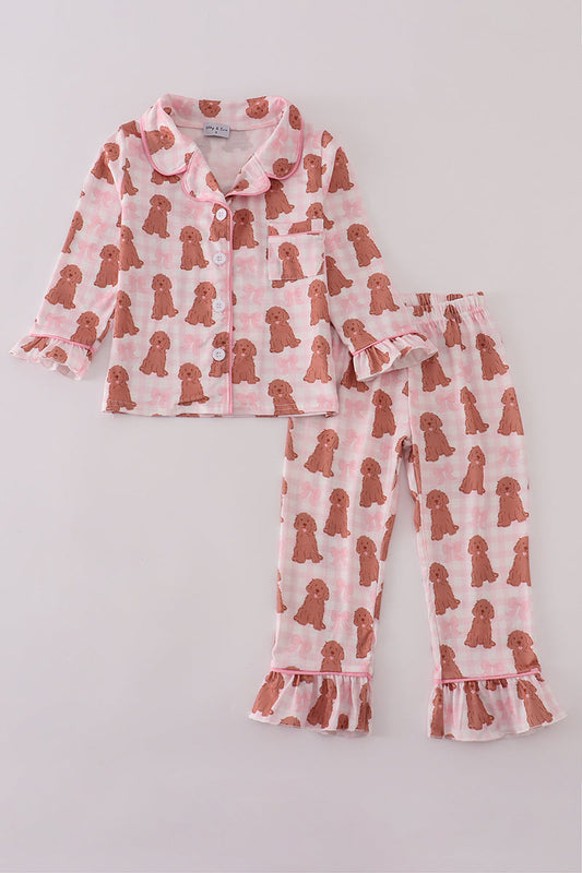 Children's pajama set with dog pattern on a light gray background