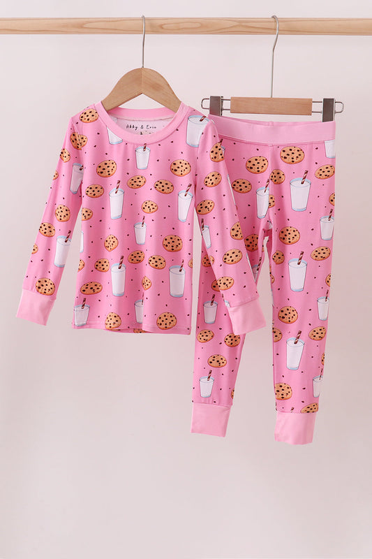 Kids pink pajama set with long sleeve top and pants featuring cookies and milk print