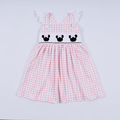 Pink checkered dress with embroidered details on a light gray background
