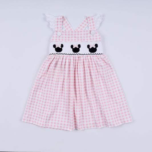 Pink checkered dress with embroidered details on a light gray background