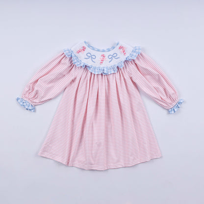 Pink and white striped dress with blue ruffled details on a light gray background