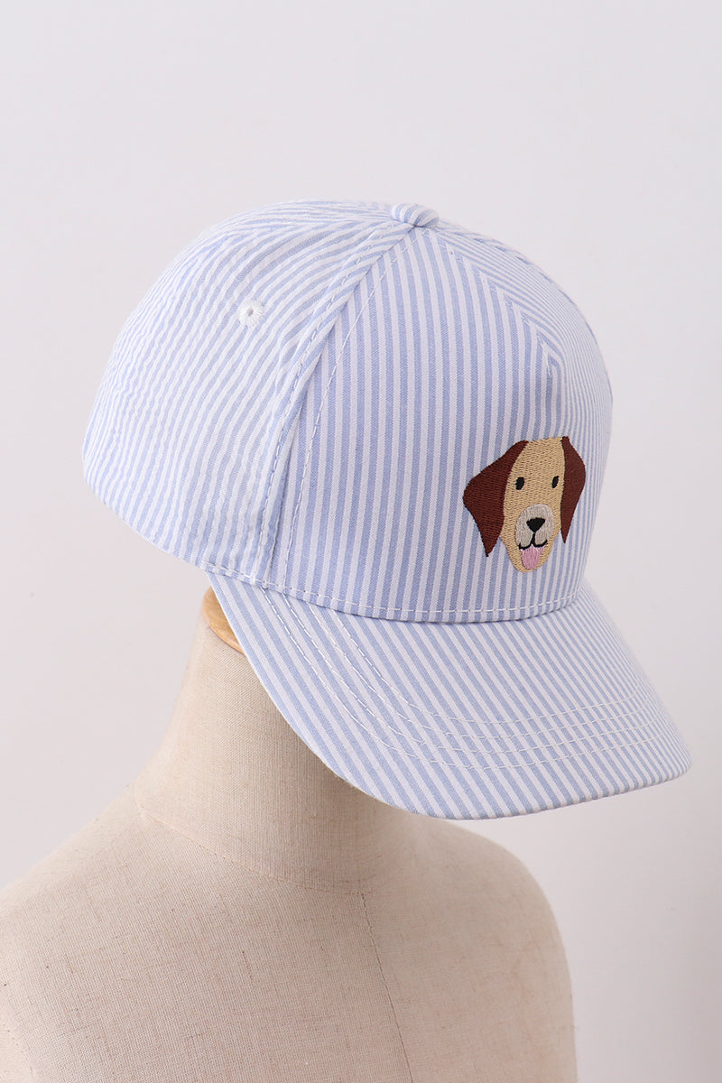 Blue striped cap with a dog face embroidery on a mannequin head against a light gray background