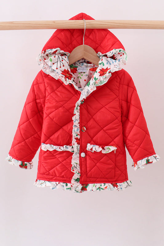 Red quilted jacket with floral trim on a wooden hanger against a light background