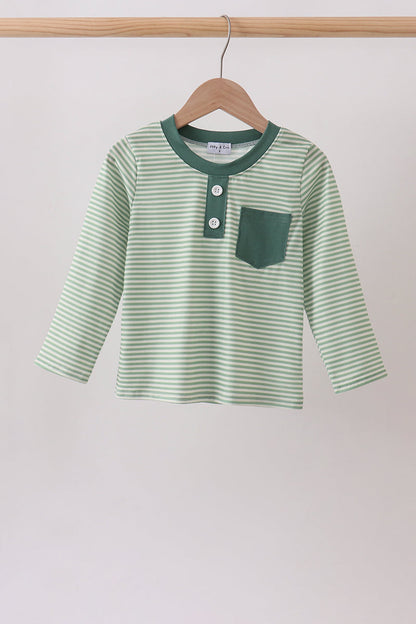 A children's long-sleeve henley shirt with light green and white horizontal stripes, featuring a solid dark green collar, button placket, and chest pocket, hanging on a wooden hanger.