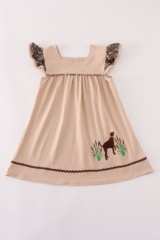 Beige dress with embroidered design on a white background