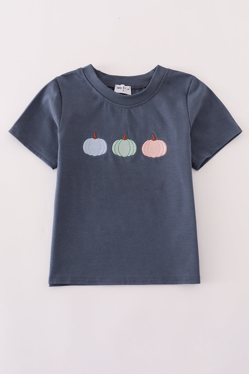 Navy blue t-shirt with embroidered pumpkins on a light gray background