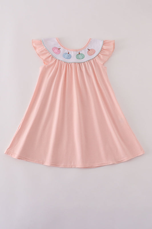 Pink dress with colorful collar on a light gray background