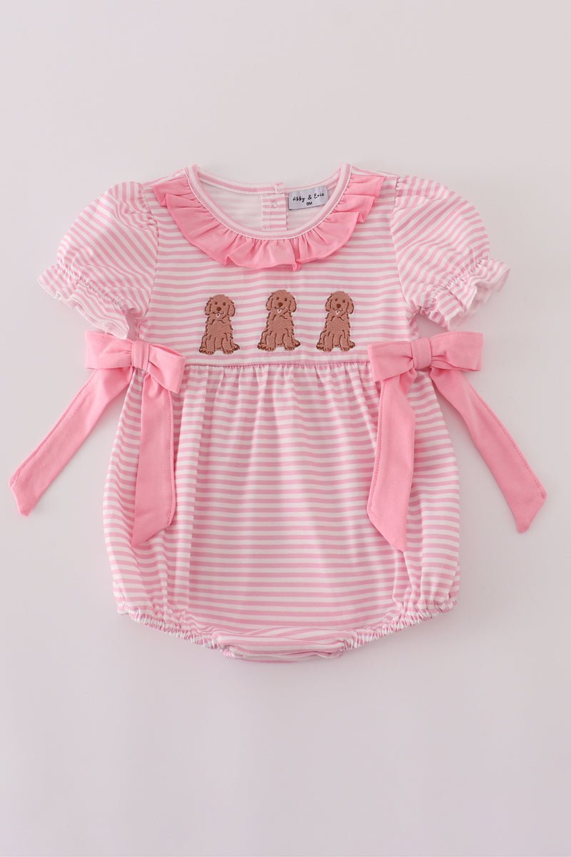 Pink and white striped baby romper with ruffled collar and bow details on a light gray background