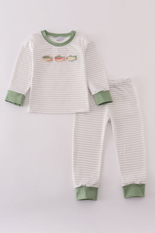 Children's striped pajama set with green accents on a light gray background